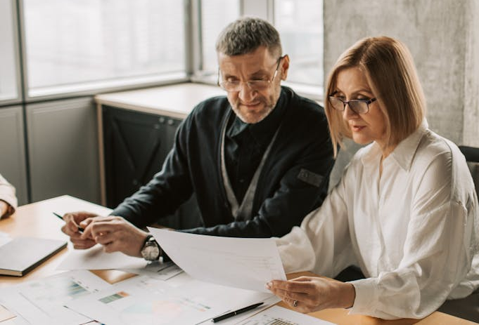 a man and woman look through documents together